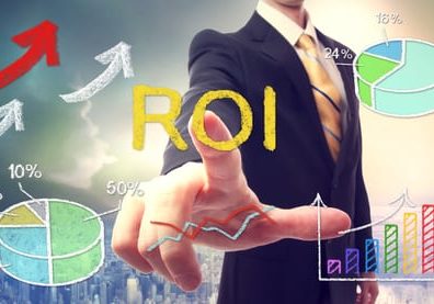 Businessman touching ROI (return on investment) over skyline background